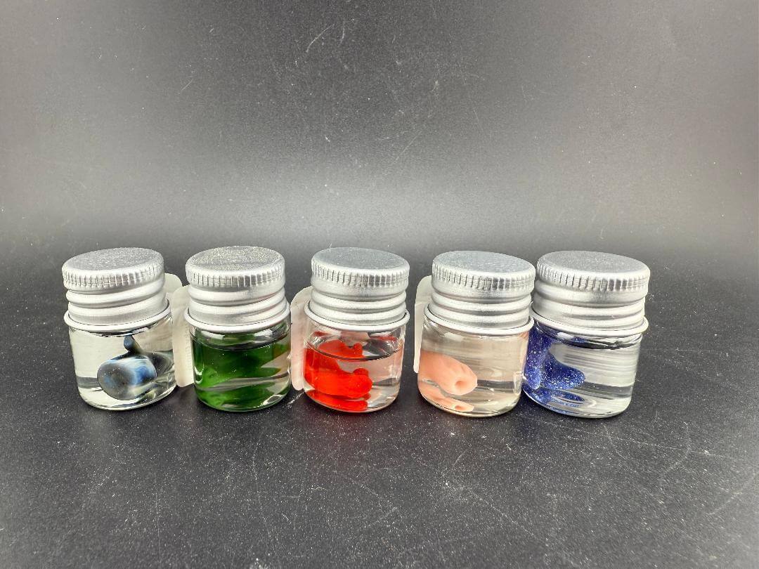 Lucky Gnome Glass Terp Pearl - Boxing glove in various jars showcasing colorful designs.