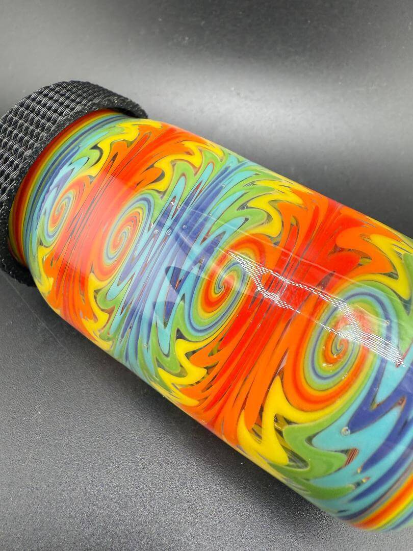 Colorful McDoogle Glass Baller Jar featuring a swirl pattern in vibrant colors and a textured black lid.
