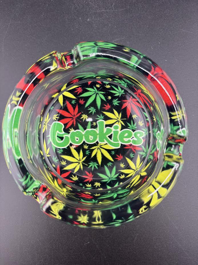 Cookies Glass Ashtray featuring colorful cannabis leaf design and bold Cookies logo.