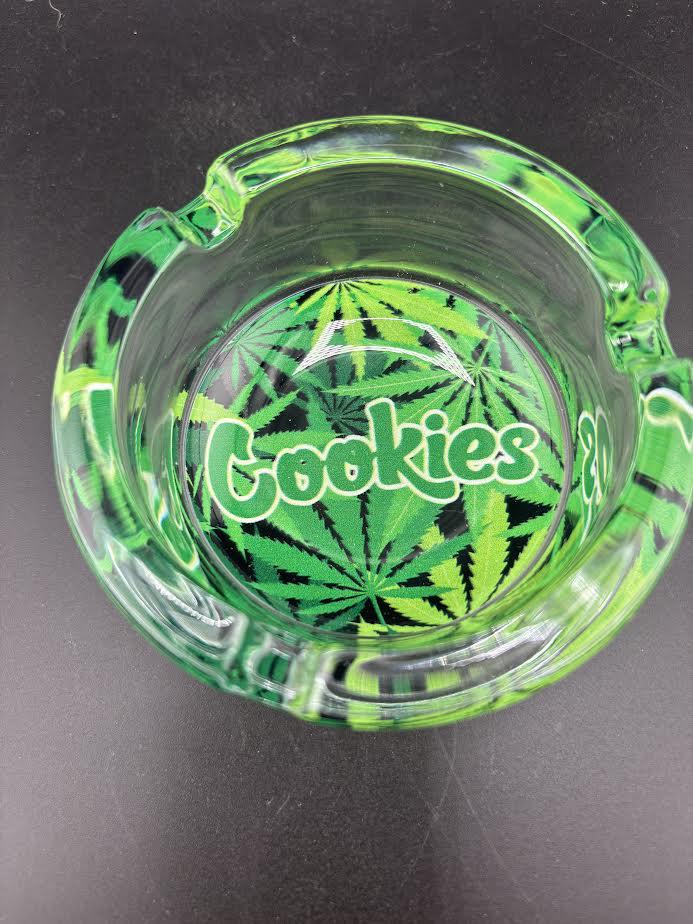 Cookies Glass Ashtray with bold Cookies logo and green marijuana leaf design.