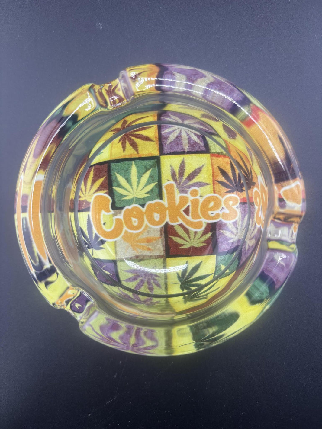 Top view of Cookies Glass Ashtray featuring vibrant colors and cannabis leaf design.