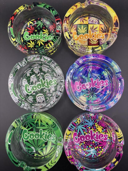 Set of six colorful Cookies Glass Ashtrays with various designs featuring the iconic Cookies logo.