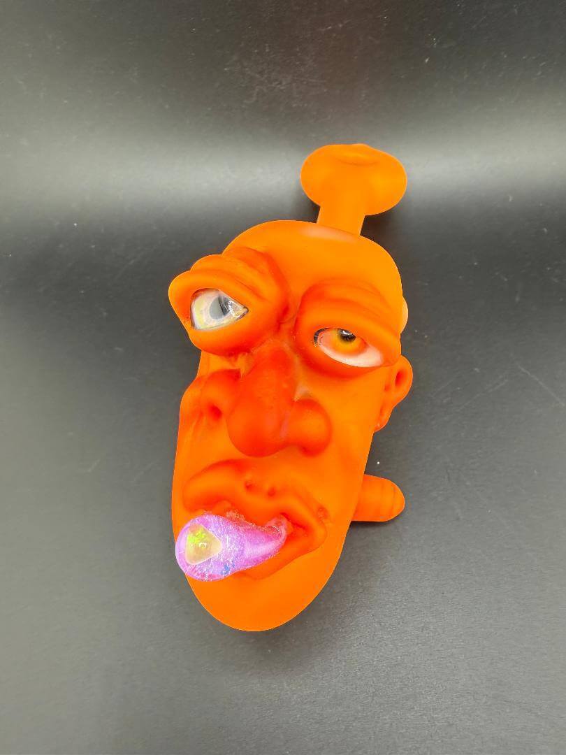 Crondo Face Pipe Sherlock, unique orange face-shaped smoking pipe with playful design and vibrant colors.