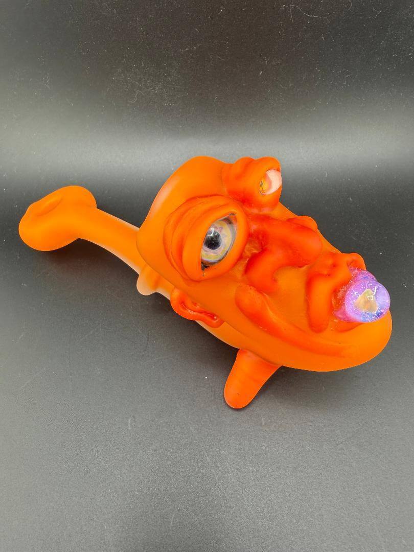 Crondo Face Pipe Sherlock in vibrant orange featuring a unique facial design with eye and flower details.