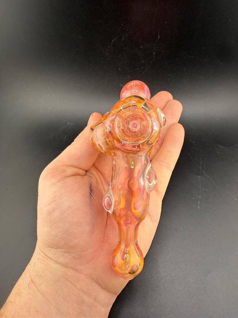 Crondo Glass Hammer Pipe - Heavy Fume held in hand, showcasing its vibrant colors and unique design.