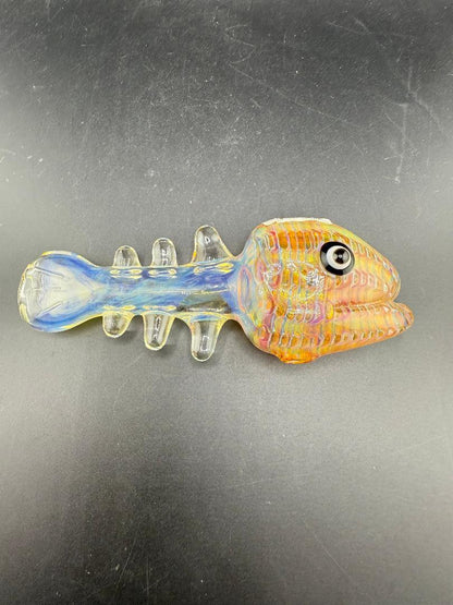 Crondo Glass Hand Pipe - Fumed Fish Skeleton, hand-sculpted glass with intricate fish design, color-changing properties.