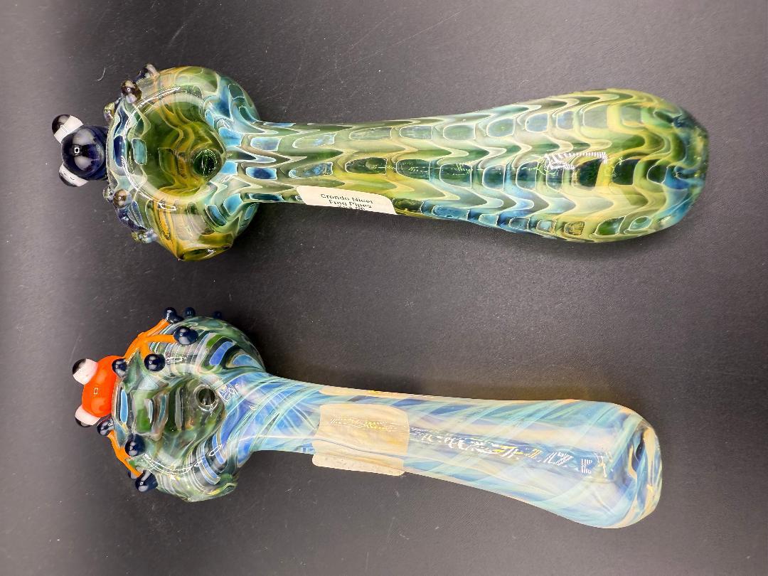 Crondo Glass Hand Pipe - Fumed w/ Sculpted Frog, showcasing two colorful pipes with unique frog designs.