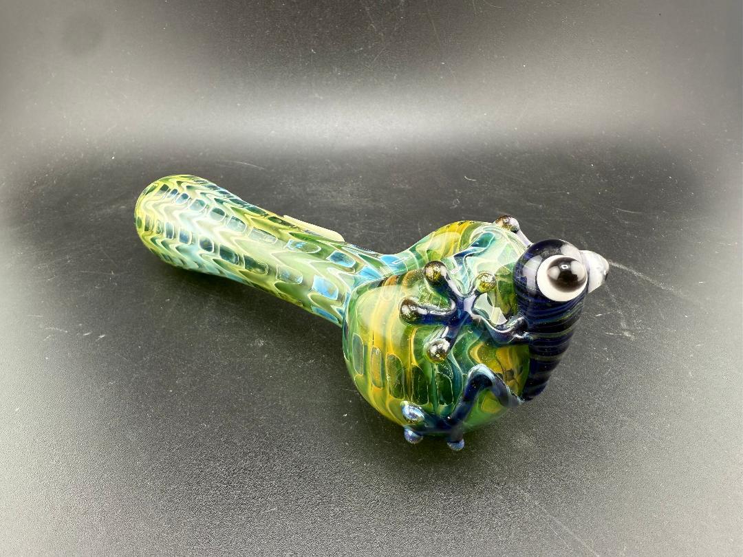 Crondo Glass Hand Pipe - Fumed w/ Sculpted Frog featuring vibrant colors and a charming frog decoration.