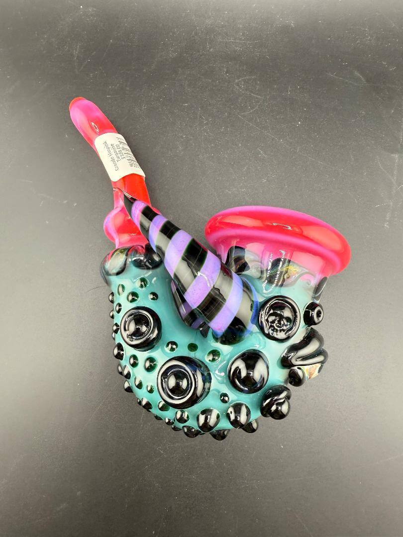 Crondo Glass Sherlock Pipe - Hotpink & Teal w/ Eyeball, Line Worked Horns & Sculpting displayed on a black background.