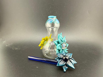 Pablos Glass Flower Jar with colorful flower designs, featuring a blue and yellow glass accent and a matching spoon.