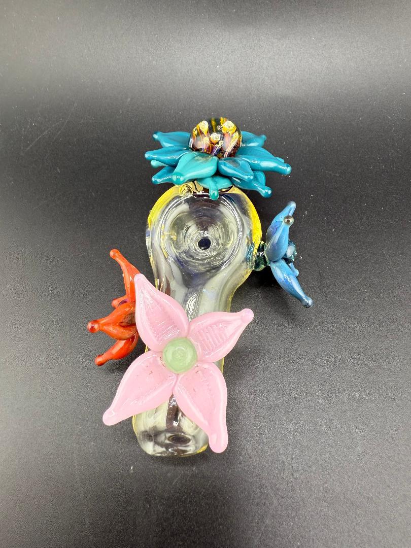 Pablos Glass Flower Hand Pipe featuring colorful floral designs and intricate glasswork.