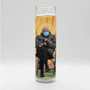 Bobbyk Saint Candles featuring a whimsical depiction of a sitting figure in winter attire and mask.