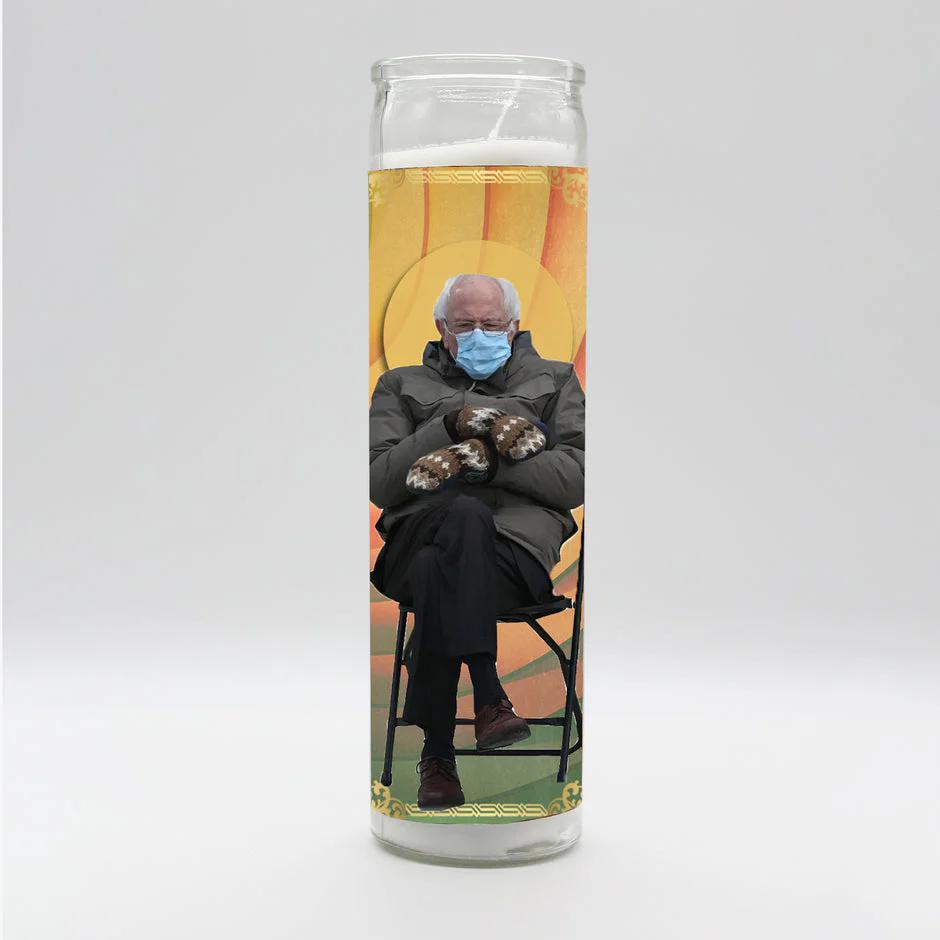 Bobbyk Saint Candles featuring a whimsical depiction of a sitting figure in winter attire and mask.