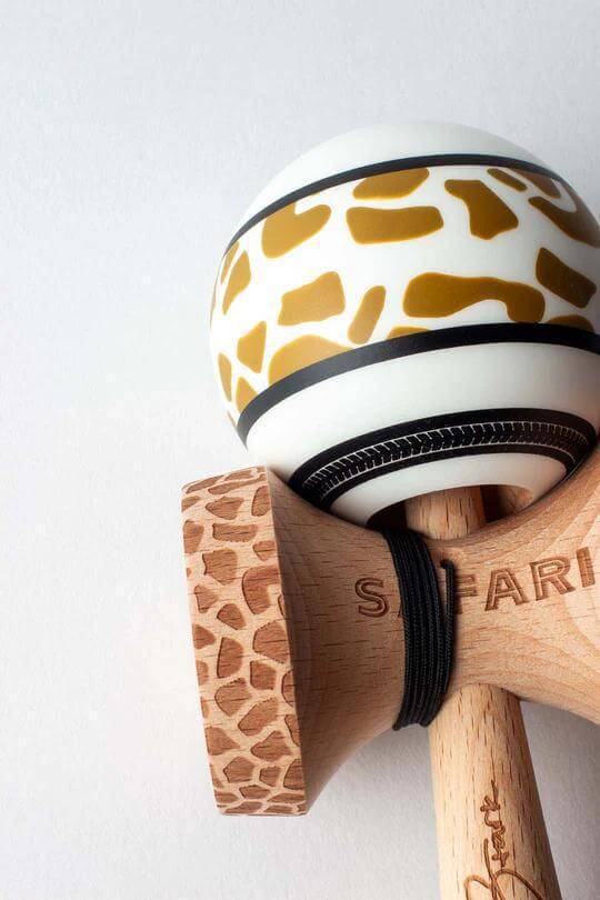 Sweets Kendama Reed Stark Gold Safari kendama featuring a giraffe print and natural wood handle.