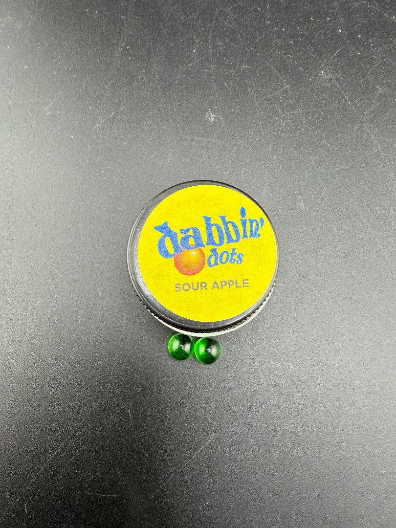 Dabbing Dots - Terp Pearls in green color beside a yellow lid container labeled 'Sour Apple'.