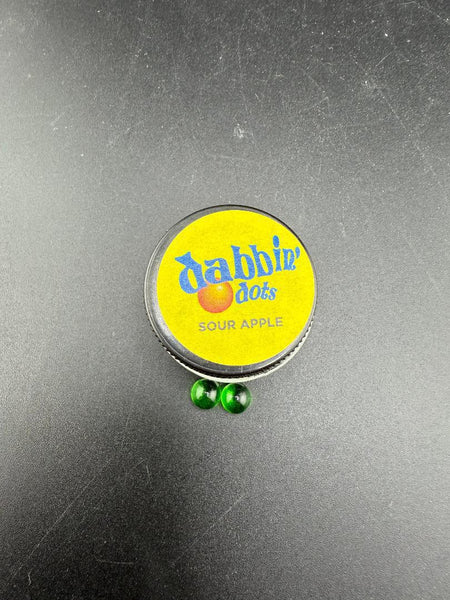 Dabbing Dots - Terp Pearls in green color beside a yellow lid container labeled 'Sour Apple'.