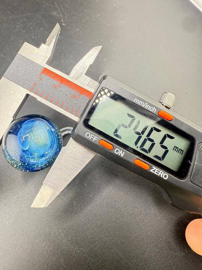 Danny W Glass Marble - 24mm Blue Bubble Trap / Implosion measured with caliper, showcasing 24.65mm diameter.
