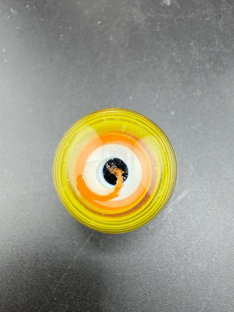 Danny W Glass Marble - 29mm Multi Layered Yellow & Orange showcasing vibrant hues from a top view.