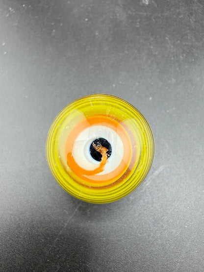 Danny W Glass Marble - 29mm Multi Layered Yellow & Orange showcasing vibrant hues from a top view.