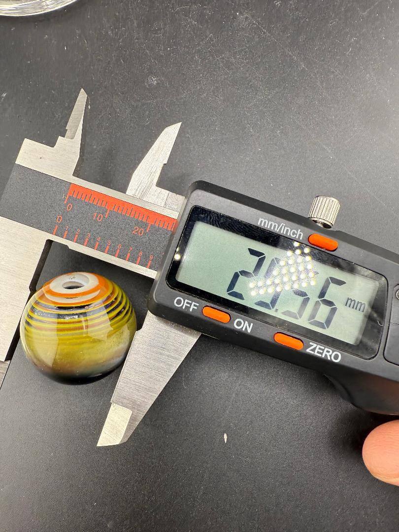 Danny W Glass Marble - 29mm Multi Layered Yellow & Orange measured with caliper showing 29.36mm diameter.