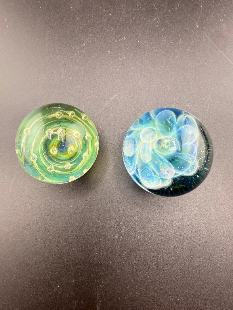 Danny W Glass Marble - 32mm Green Bubble Trap / Implosion displayed with dynamic green and blue designs on a dark background.