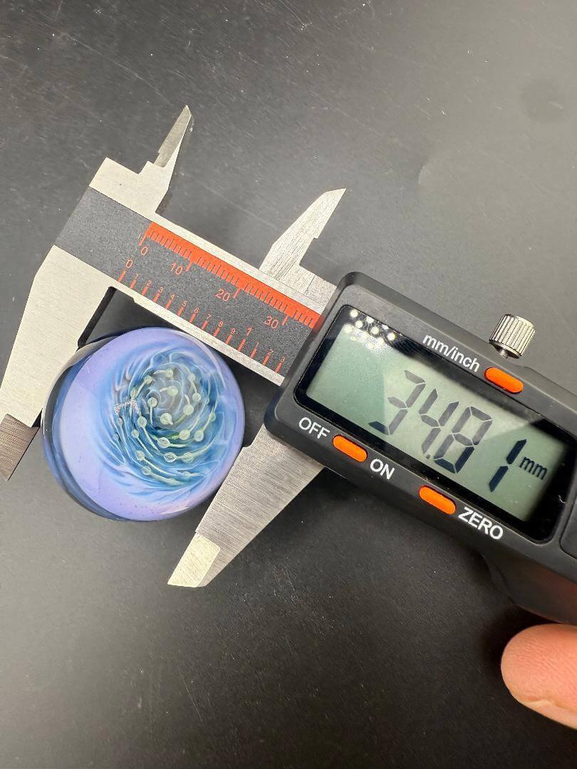 Danny W Glass Marble - 34mm Purple Bubble Trap Implosion measured with caliper showing 34.81mm diameter.