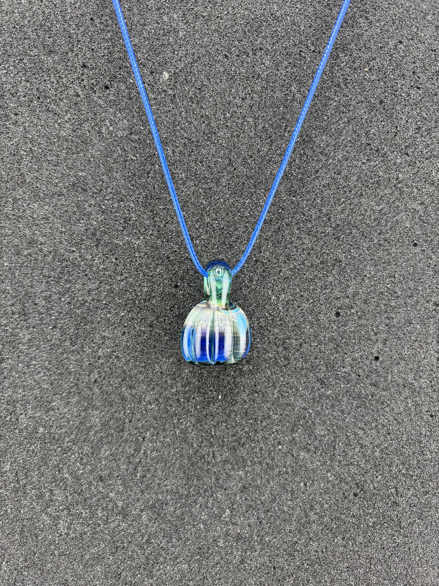 Danny W Pumpkin Pendant - Blue handcrafted pendant on a blue cord, showcasing whimsical autumn charm.