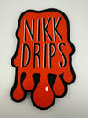 MoodMats x Nikk Drips classic logo design in orange and black, highlighting unique drips style.