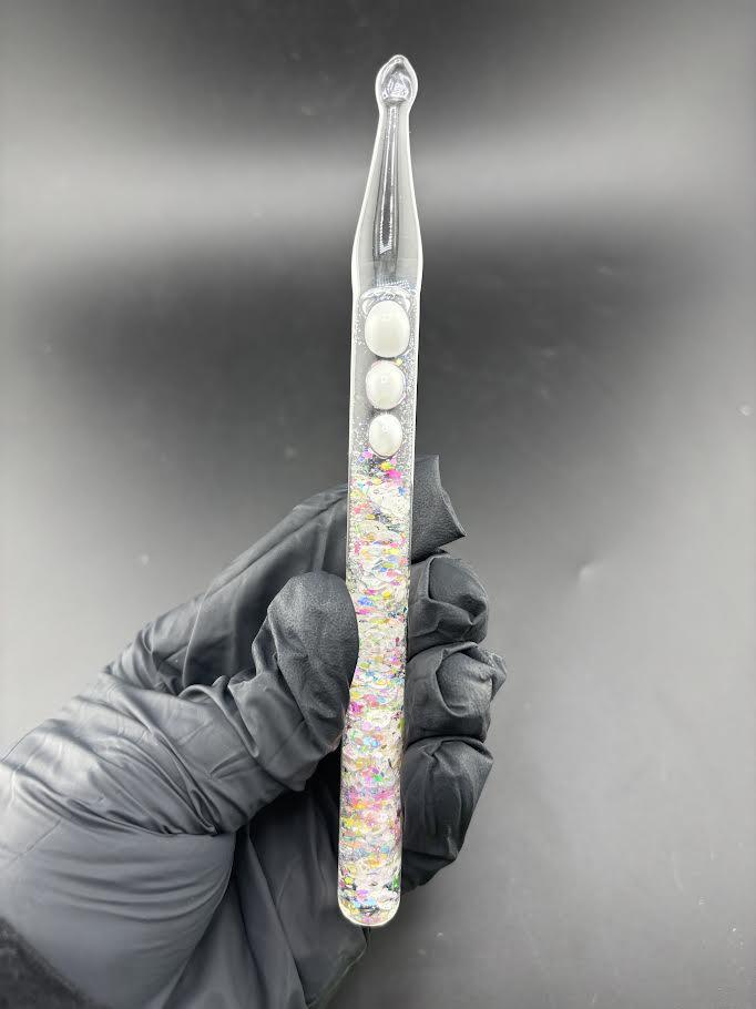 Dollhouse Glass Glitter Dab Tool with shimmering glitter designs in a durable handle, held in a gloved hand.