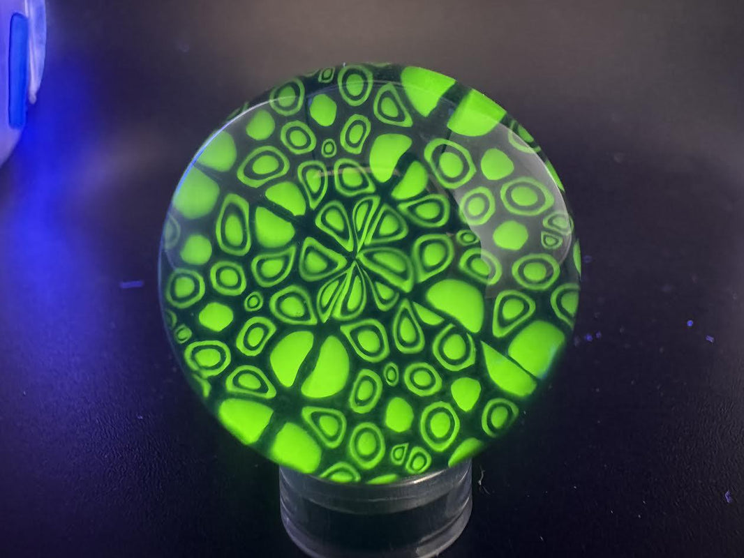 Domer Glass Marble - Blue Mitosis Millie Chip Stack UV showcasing an intricate design in vibrant greens.
