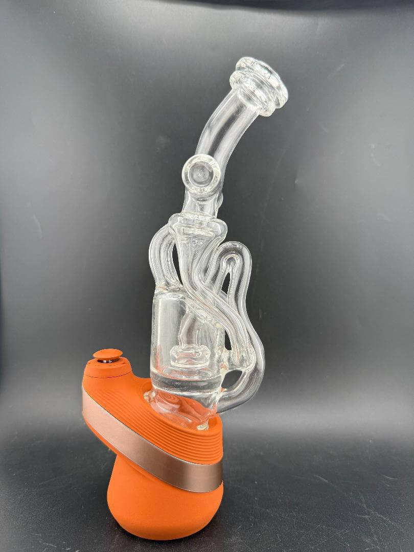 Domer Glass Puffco Peak Glass Attatchment - Double recycler showcased next to vibrant orange base.