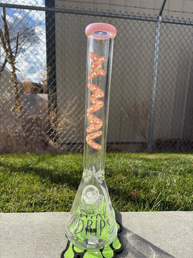 MAV Glass 9mm thick 18" Beaker 14mm 45° - Unicorn with pink accents and whimsical design on a grassy surface.