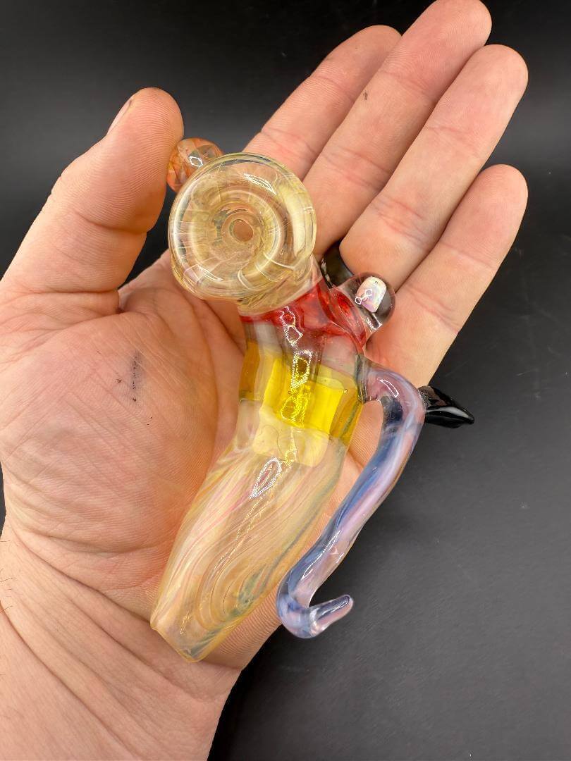 Dunnwright Glass Sidecar Pipe - Fumed w/ Horn, Moldavite & Opal Encasement held in a hand.