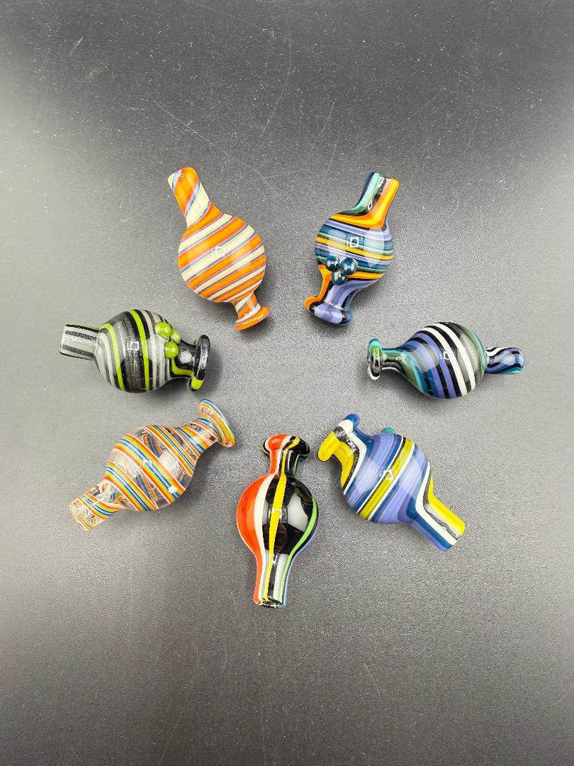 Colorful collection of Filla John Line Worked Bubble Caps, showcasing intricate line work and designs.
