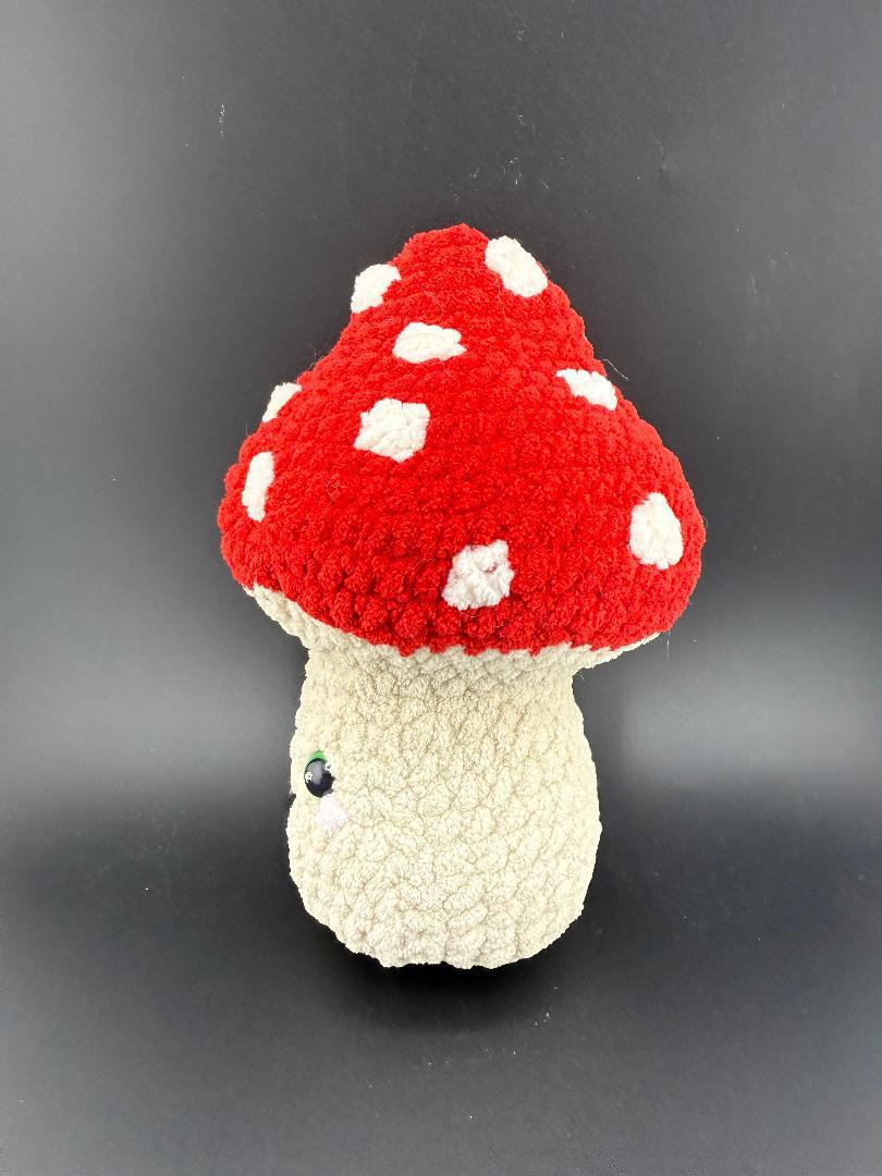 Adorable crochet mushroom plushy with red and white polka dots, perfect for kids' decor and gifts.