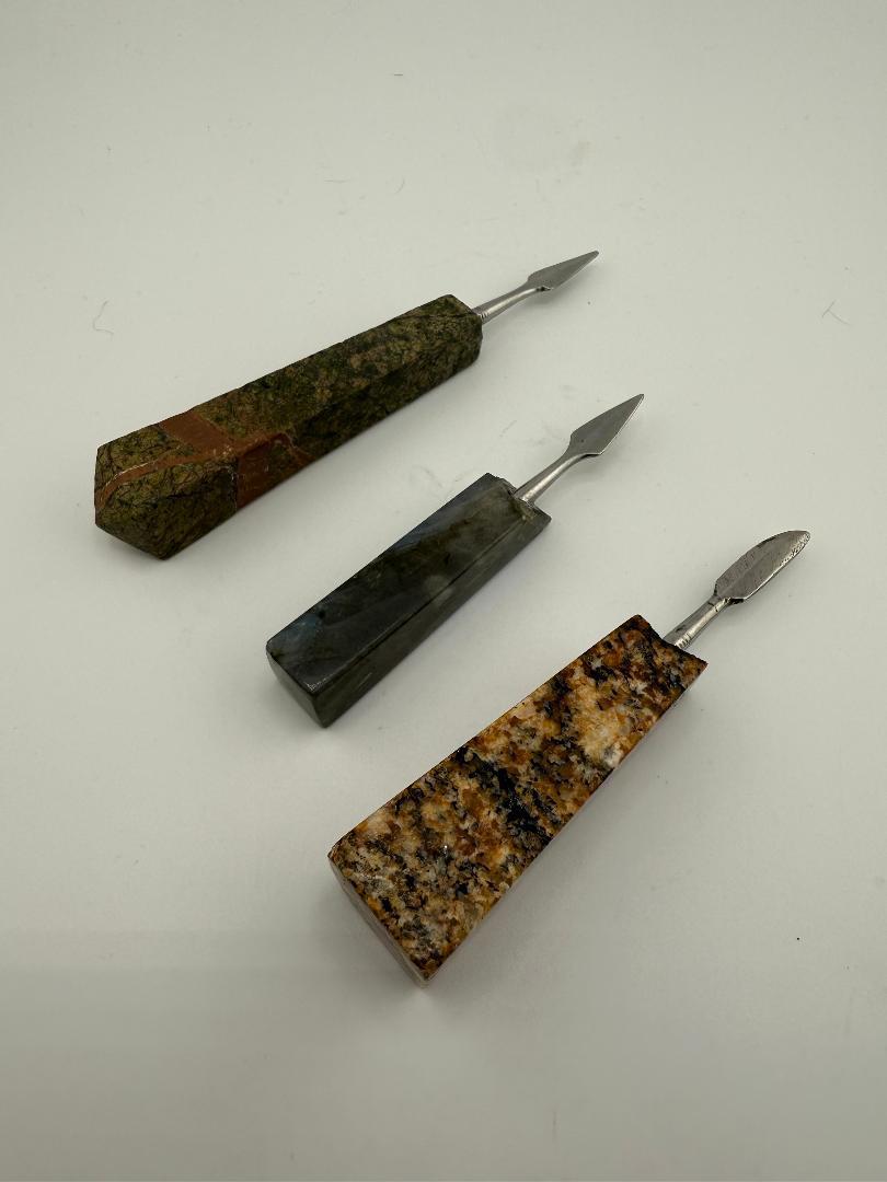 Three unique handcrafted stone dab tools, showcasing various textures and colors for precision dabbing experiences.