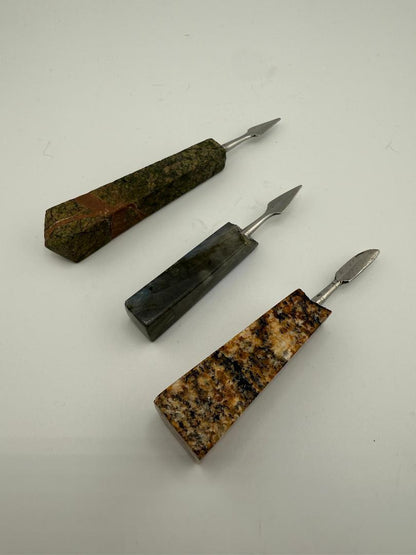 Three unique handcrafted stone dab tools, showcasing various textures and colors for precision dabbing experiences.