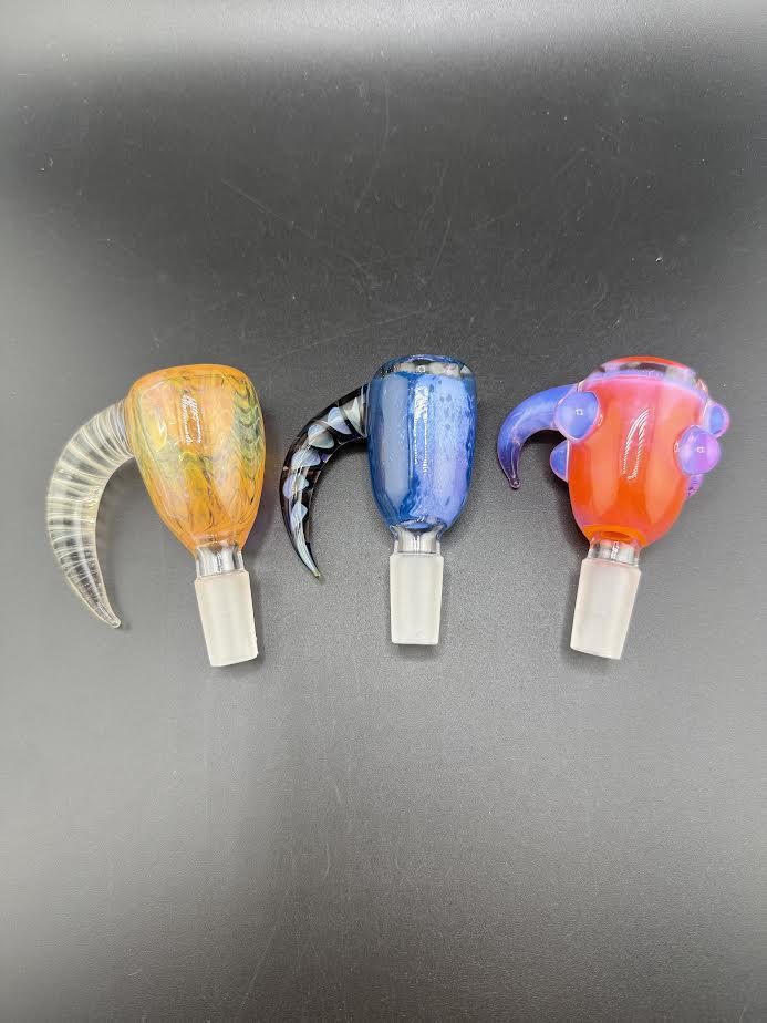 Three colorful horn slides for water pipes on a black background, showcasing unique designs and smooth finishes.