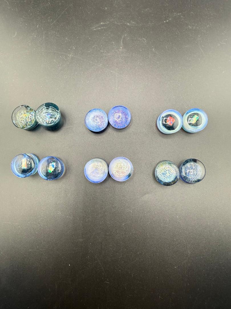 Mop Head Glass Gauges in blue hues, featuring unique artisan swirl designs for stretched ears, handcrafted in Spokane.