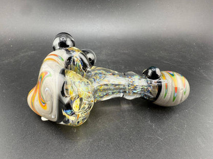 Elbow Tim Glass Hand Pipe - Fumed w/ Rainbow Wig wag Cap, Accents , & Marble Attachments on a black background.