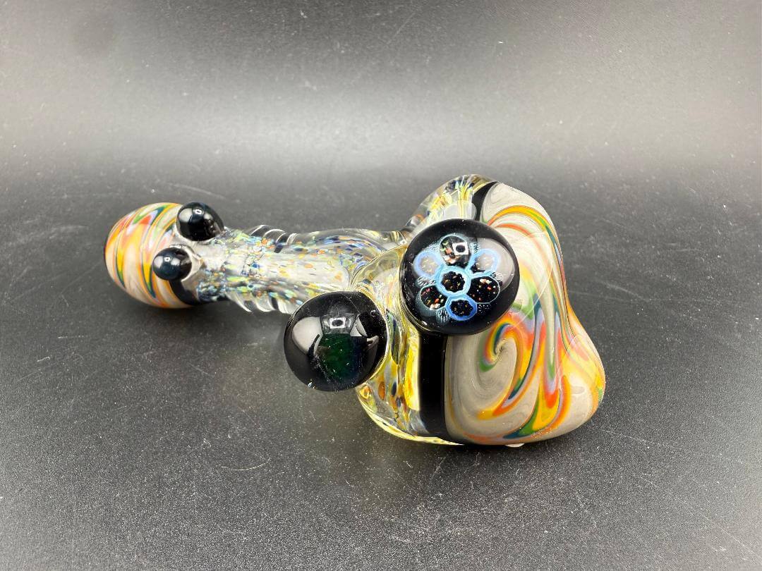 Elbow Tim Glass Hand Pipe - Fumed w/ Rainbow Wig wag Cap, Accents , & Marble Attachments on a dark background.