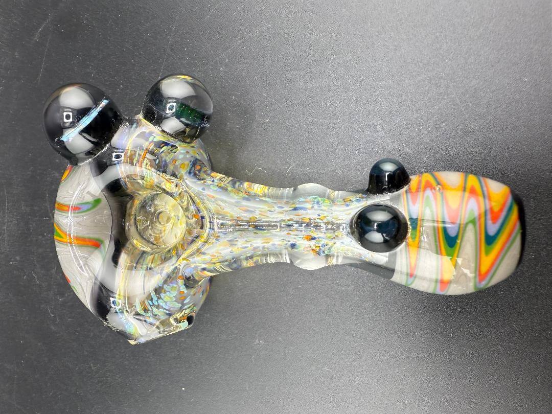 Elbow Tim Glass Hand Pipe - Fumed w/ Rainbow Wig wag Cap, Accents , & Marble Attachments on a black background.