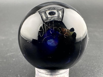 Elbow Tim Glass Marble - Opal Vortex featuring a mesmerizing vortex design and brilliant opal core.