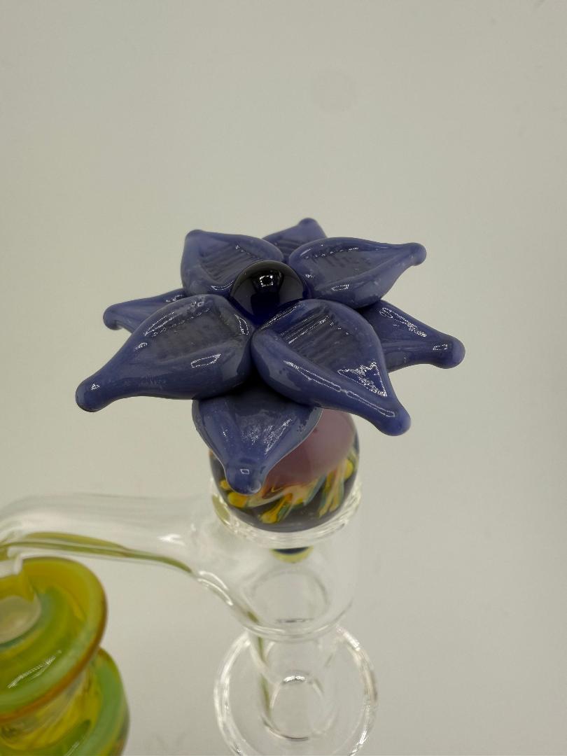 Pablos Glass Flower Slurper Top featuring a unique purple flower design on a glass piece.