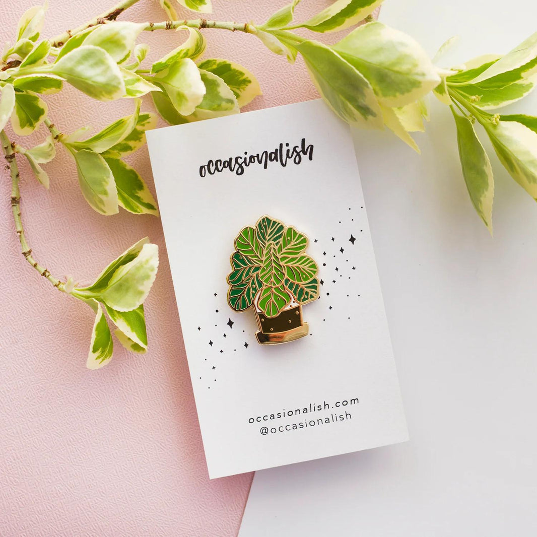 Occasionalish Enamel Pin - Fiddle Leaf Fig displayed with leafy background on a card.