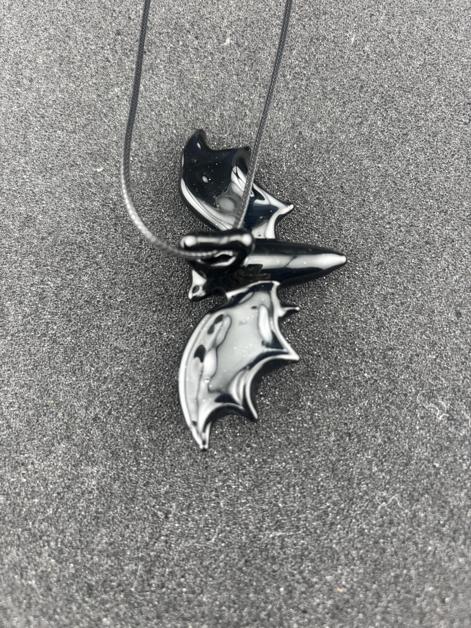 Filla John Bat Pendant featuring a stylized bat design on a necklace, handcrafted and unique.
