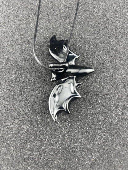 Filla John Bat Pendant featuring a stylized bat design on a necklace, handcrafted and unique.