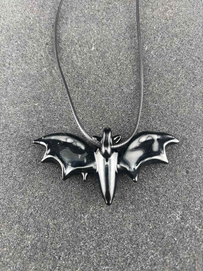 Filla John Bat Pendant featuring a handcrafted black bat design on a cord, showcasing Pacific Northwest artistry.