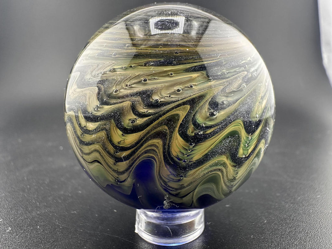 Filla John Glass Big Marble - Sparkled Swirls UV showcasing intricate swirling patterns and glowing colors.