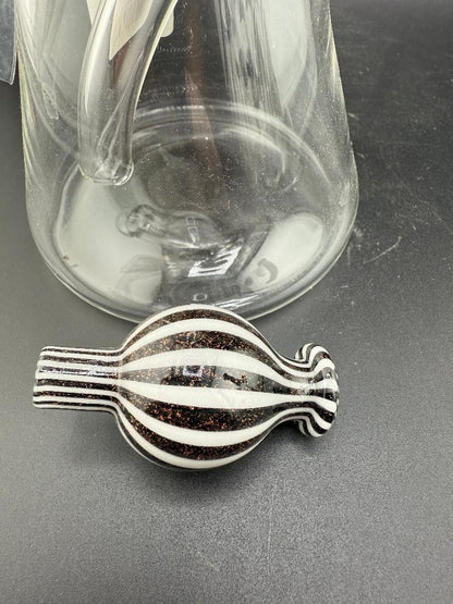 Filla John Glass Dichro Neck Beaker10mm 45° w/ Matching Cap and a clear glass container in background.